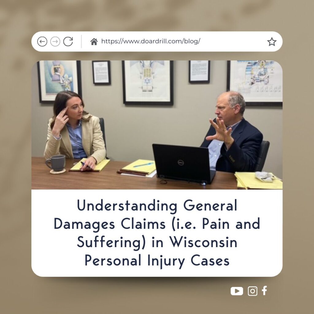 Two legal professionals engaged in discussion at a conference table, symbolizing the importance of understanding general damages in Wisconsin personal injury cases.